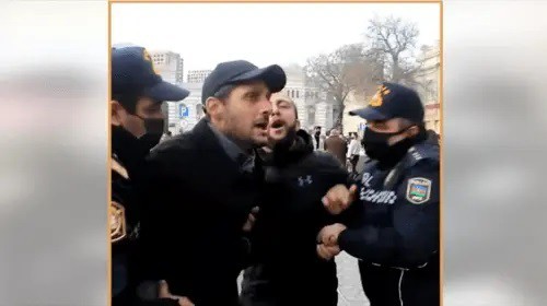 Police detain activists at a rally in support of Salekh Rustamov, Baku, December 11, 2021. Screenshot: https://www.facebook.com/watch/?v=347679063596939&extid=NS-UNK-UNK-UNK-IOS_GK0T-GK1C&amp;ref=sharing
