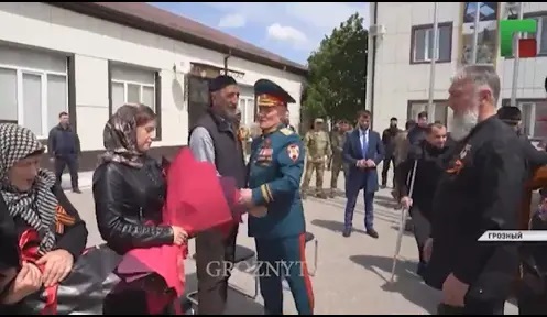 Rewarding relatives of those who died in Ukraine, May 9, 2022, Chechnya. Image made from video posted by ChGTRK ‘Grozny’ https://www.instagram.com/p/CdXlqVlDnHJ/