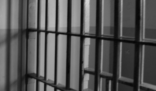 Prison bars. Photo: https://blkoutuk.com/wp-content/uploads/2015/10/csc_0110-scaled.jpg