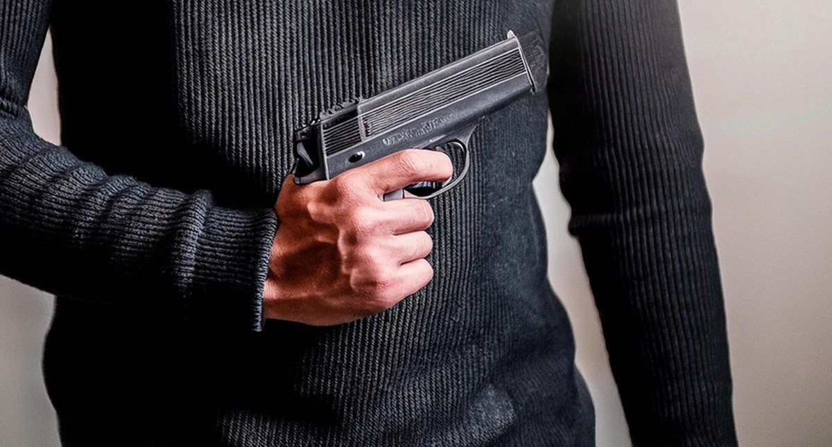 A man with a pistol: Illustration created by the "Caucasian Knot" using the AI in the Photoshop software.