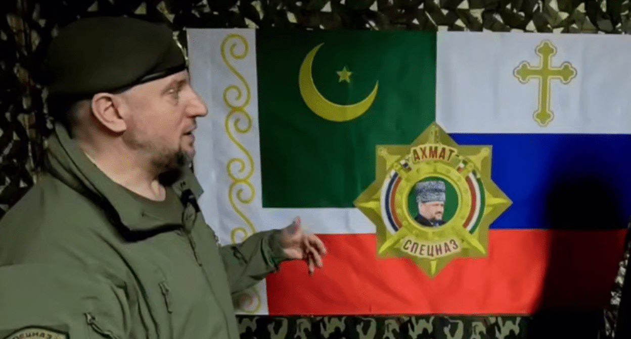 Apti Alaudinov is standing against the background of the “Akhmat” special forces flag. A screenshot from a video posted on the Anastasia Babir’s Telegram channel on May 23, 2025, https://t.me/SovaBabir/217.
