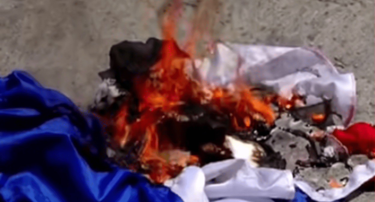 Russian flag burned in Georgia. Still frame from Pirveli TV company video from 27.07.25, https://www.youtube.com/watch?v=gwB1cRuEWBk&t=325s