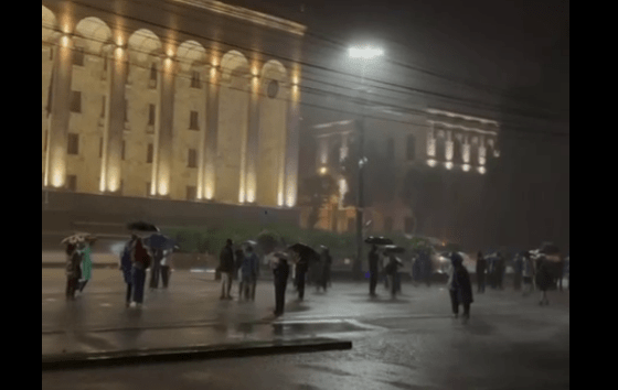 Activists under umbrellas near the Georgian parliament. Still frame from Lorena Beria's video? https://t.me/Tbilisi_life/41897