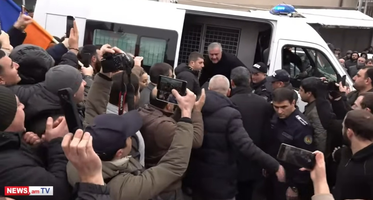 Samvel Karapetyan exits a police van. Yerevan, January 18, 2026. Still from News.am video https://www.youtube.com/watch?v=qc_cOl-QTmg