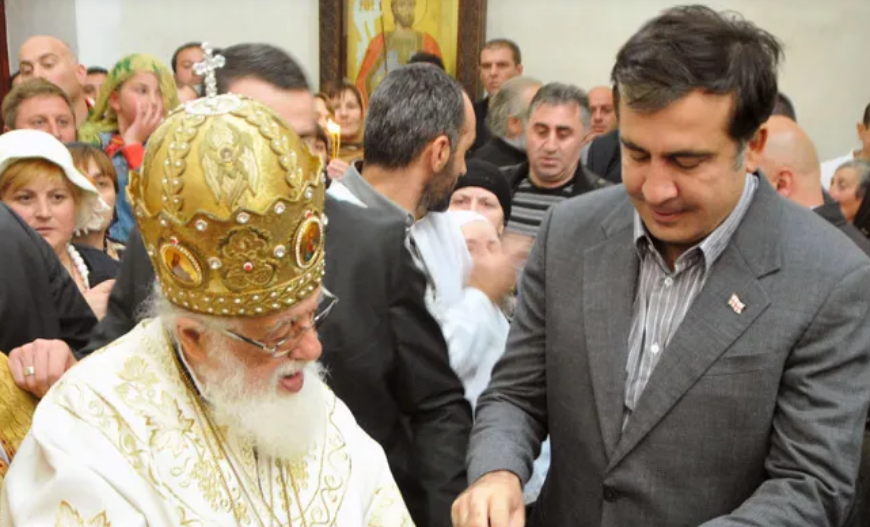 Ilia II and Mikheil Saakashvili. Screenshot from Interpressnews photo from March 19, 2026, https://www.interpressnews.ge/ru/article/173886-mikhail-saakashvili-proshu-dostavit-menia-na-pokhorony-patriarcha-kak-ego-druga-tretego-prezidenta-gruzii