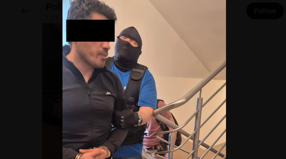 A security officer leads Elnur A. Screenshot of a Lublin police photo from 20.06.26, https://x.com/PolicjaLubelska/status/2068301027225292818/photo/1. A security officer leads Elnur A. Screenshot of a Lublin police photo from 20.06.26, https://x.com/PolicjaLubelska/status/2068301027225292818/photo/1.