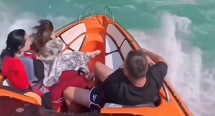 Tourists in a boat. Frame from the video on the page https://www.instagram.com/dagestan_inform/reel/Db6P_taNNjX (the activities of the company Meta (owner of Facebook, Instagram, and WhatsApp) are banned in Russia)
