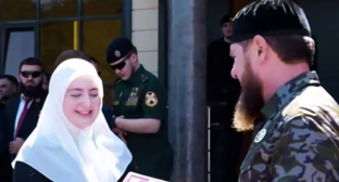 Ramzan Kadyrov awards his daughter with a medal. Frame from the video dated 21.08.26, https://t.me/MDaudov_95/3175