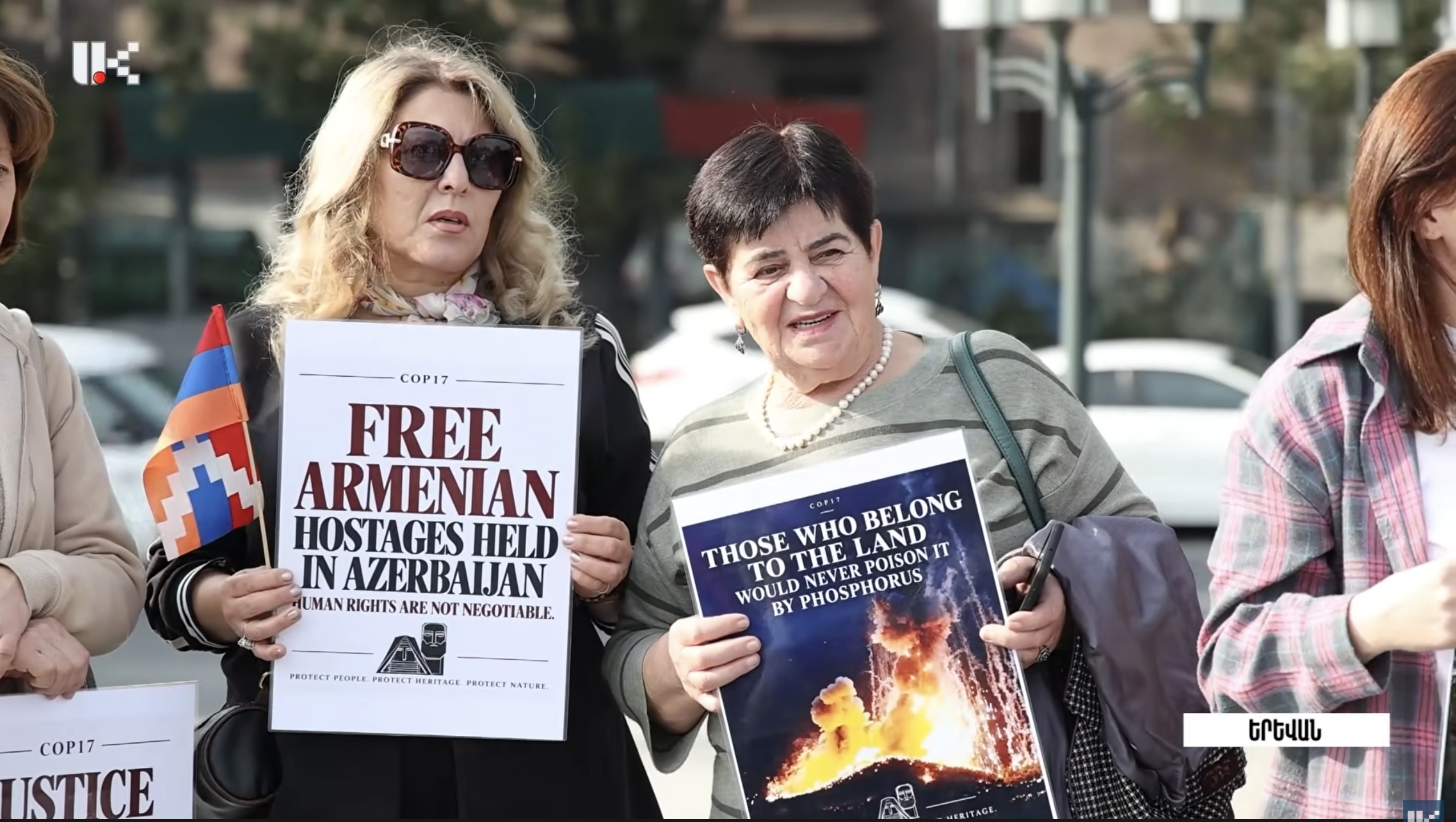 Activists with posters near the entrance to the “green zone” of COP17. Frame from the video report Artsakh Public TV / YouTube